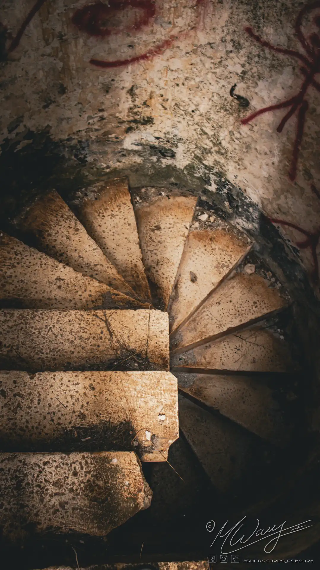 a spiral staircase with concrete steps