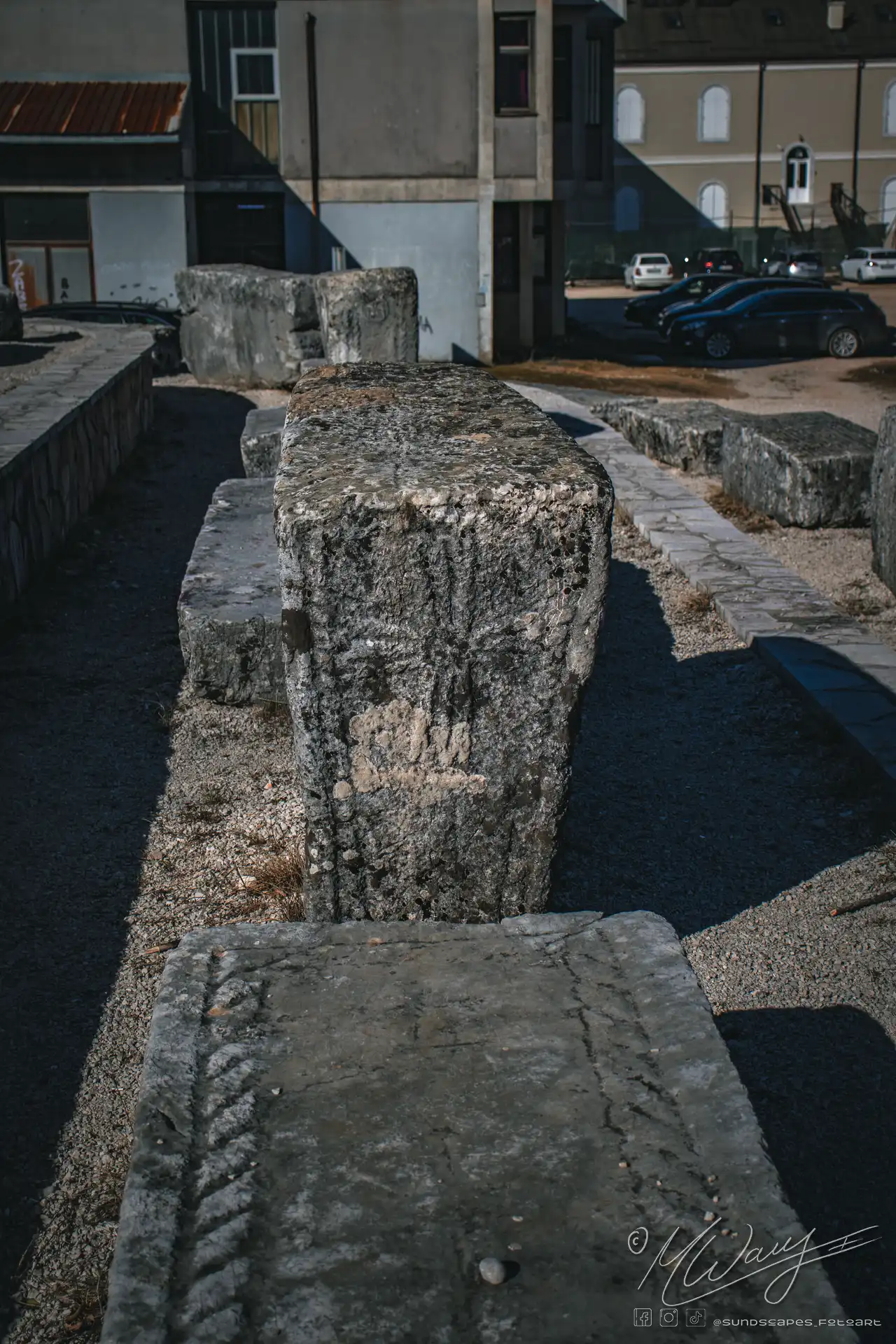 a large stone blocks in a parking lot