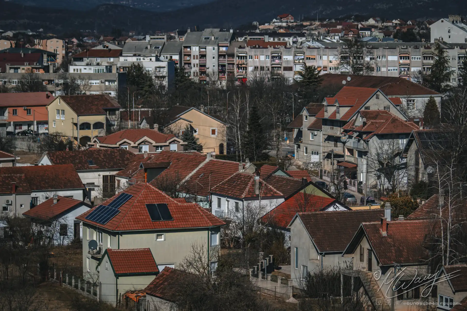 a group of houses with red roofs