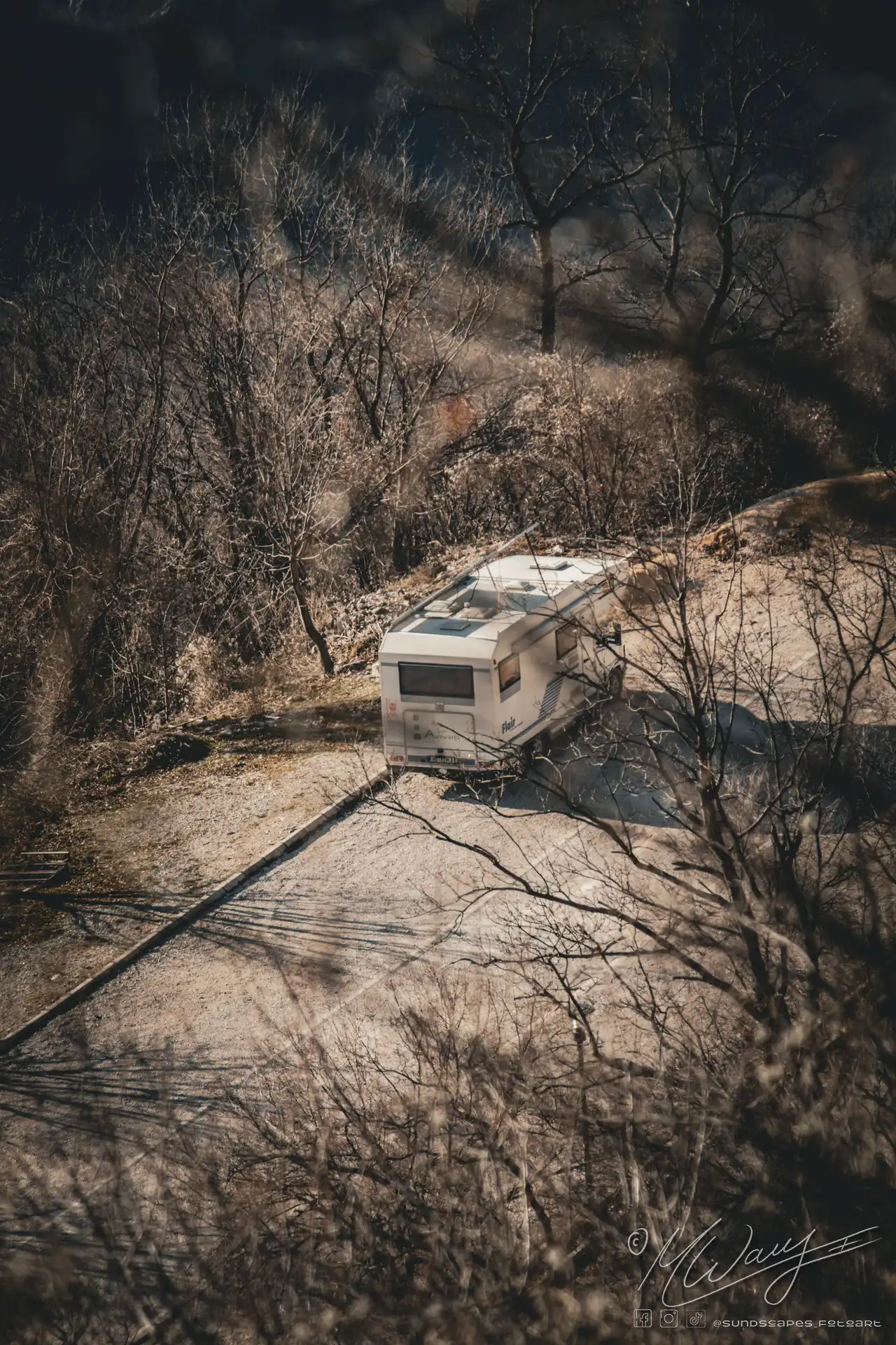 a white trailer on a dirt road