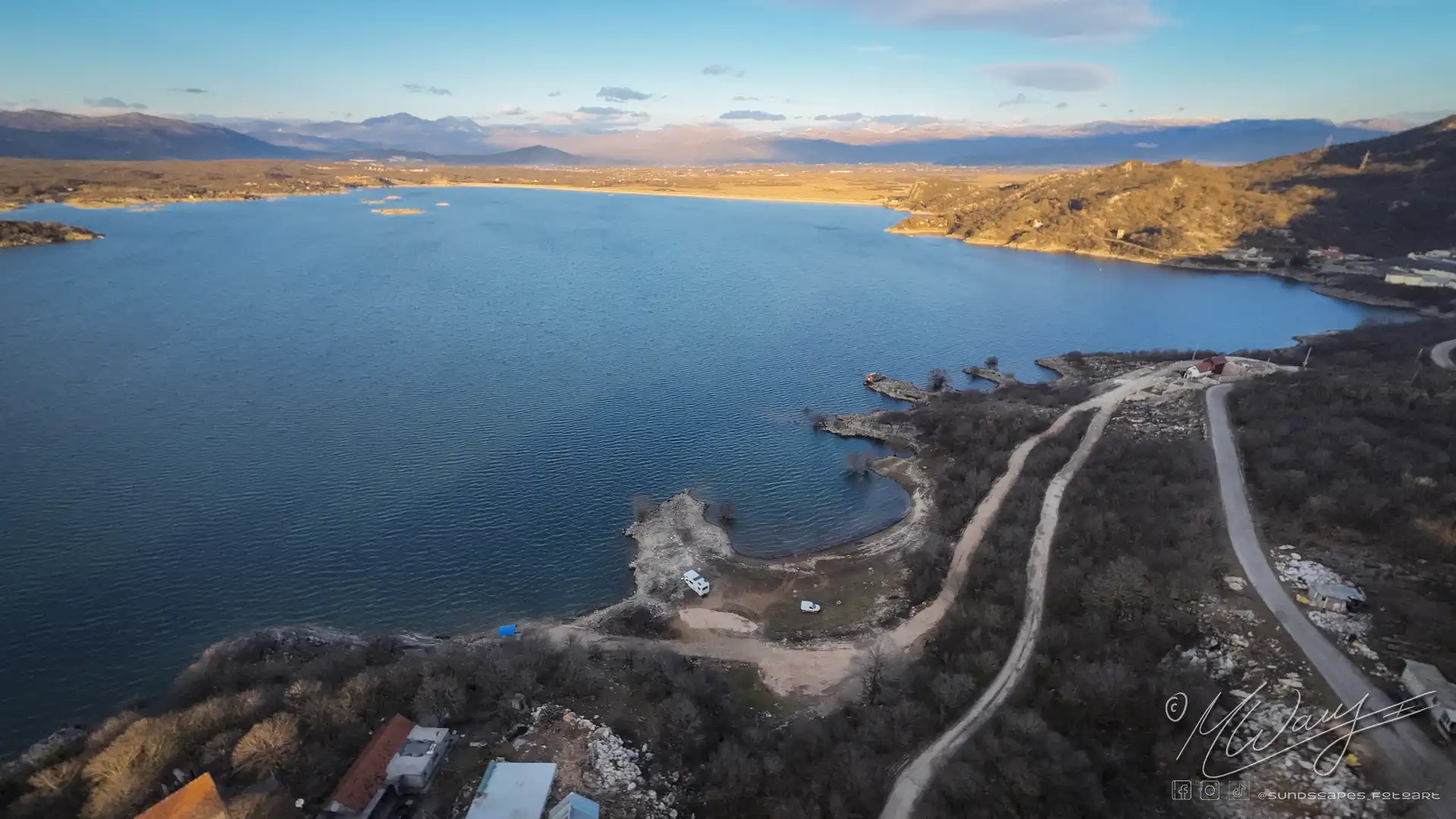 a road next to a body of water