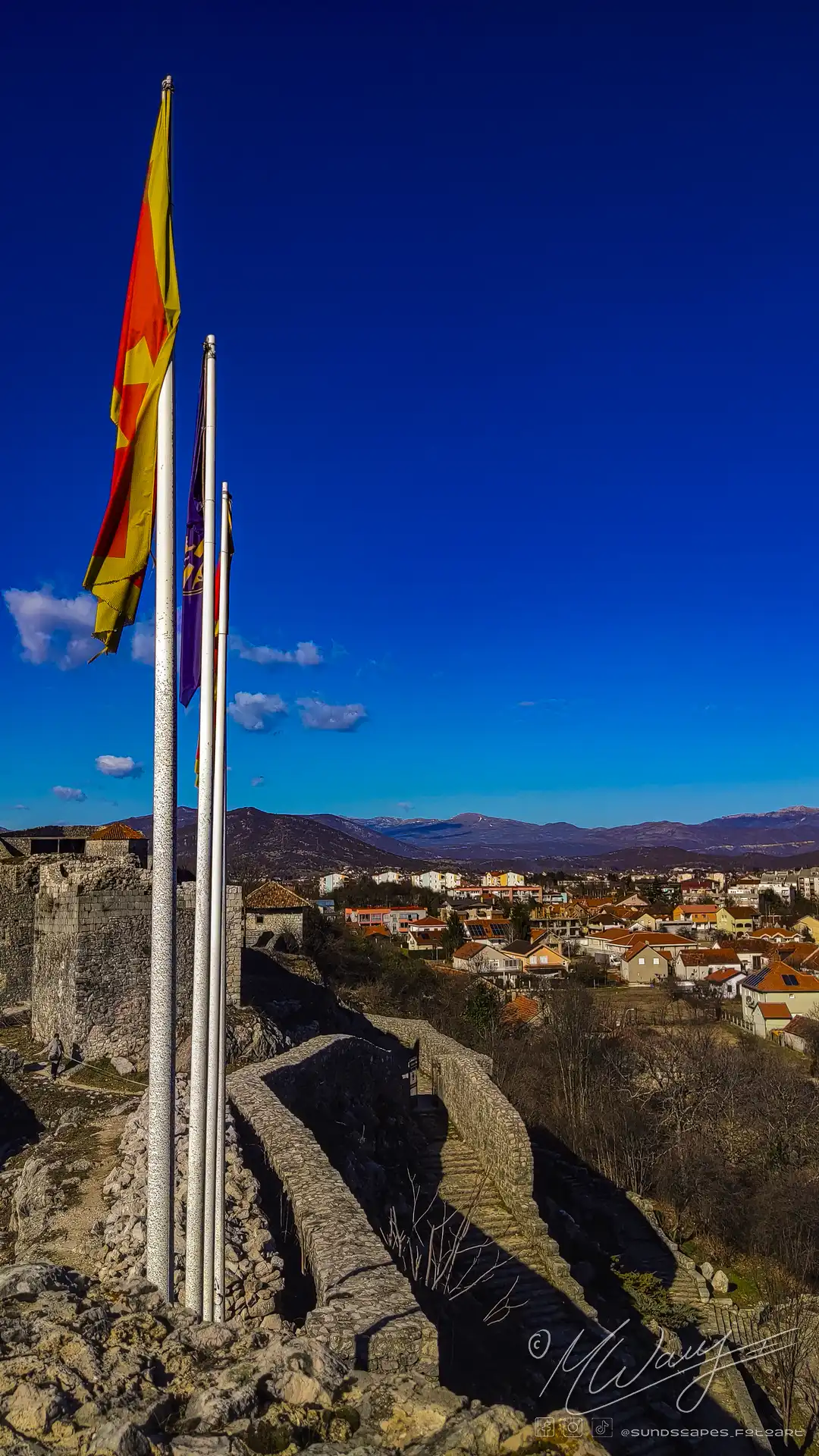 a group of flags on a pole