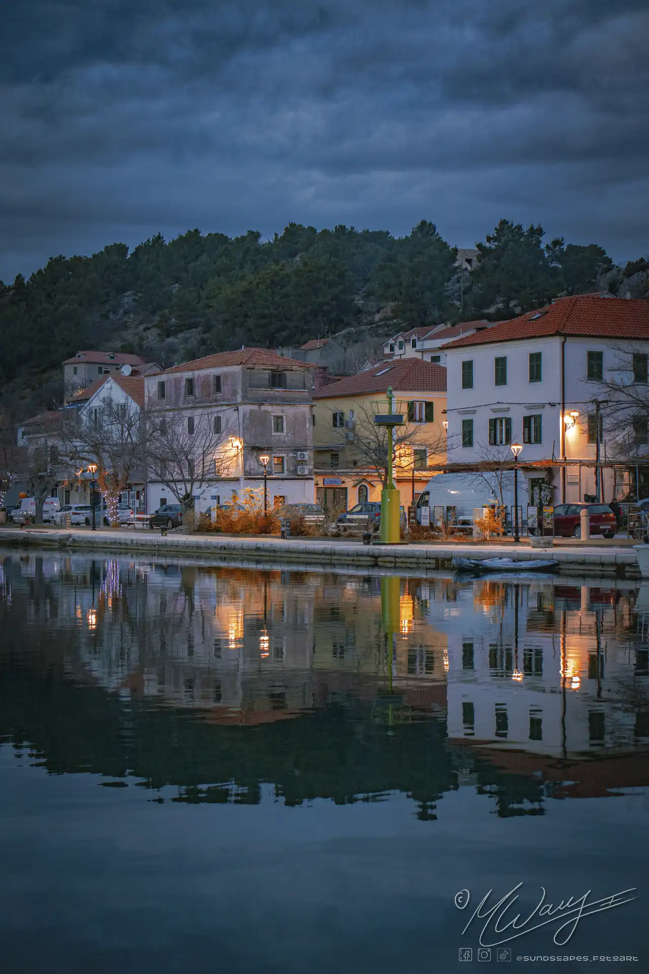 a row of buildings next to a body of water