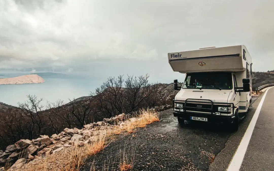 a white camper van parked on a road in Croatia