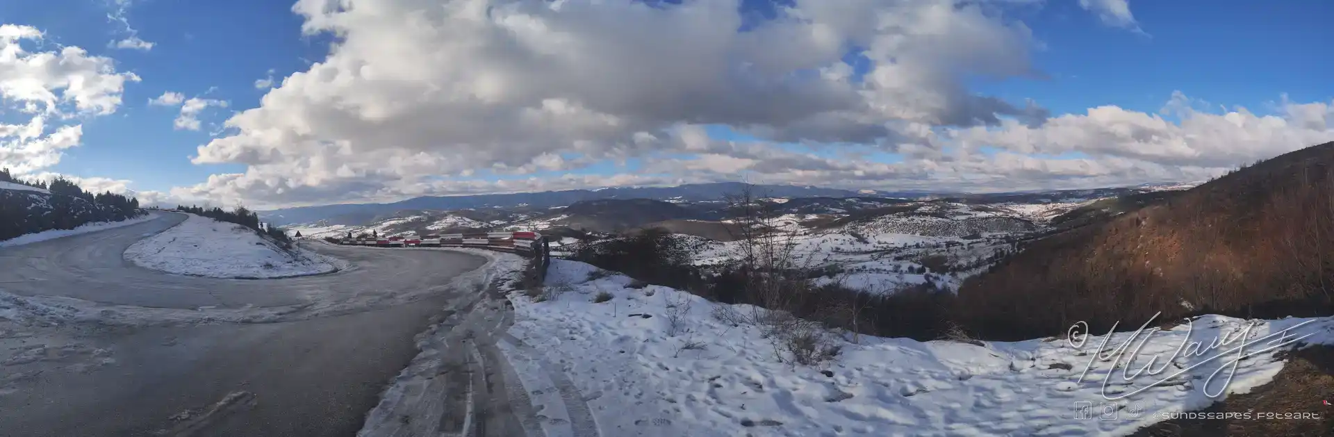 a road with snow on the side