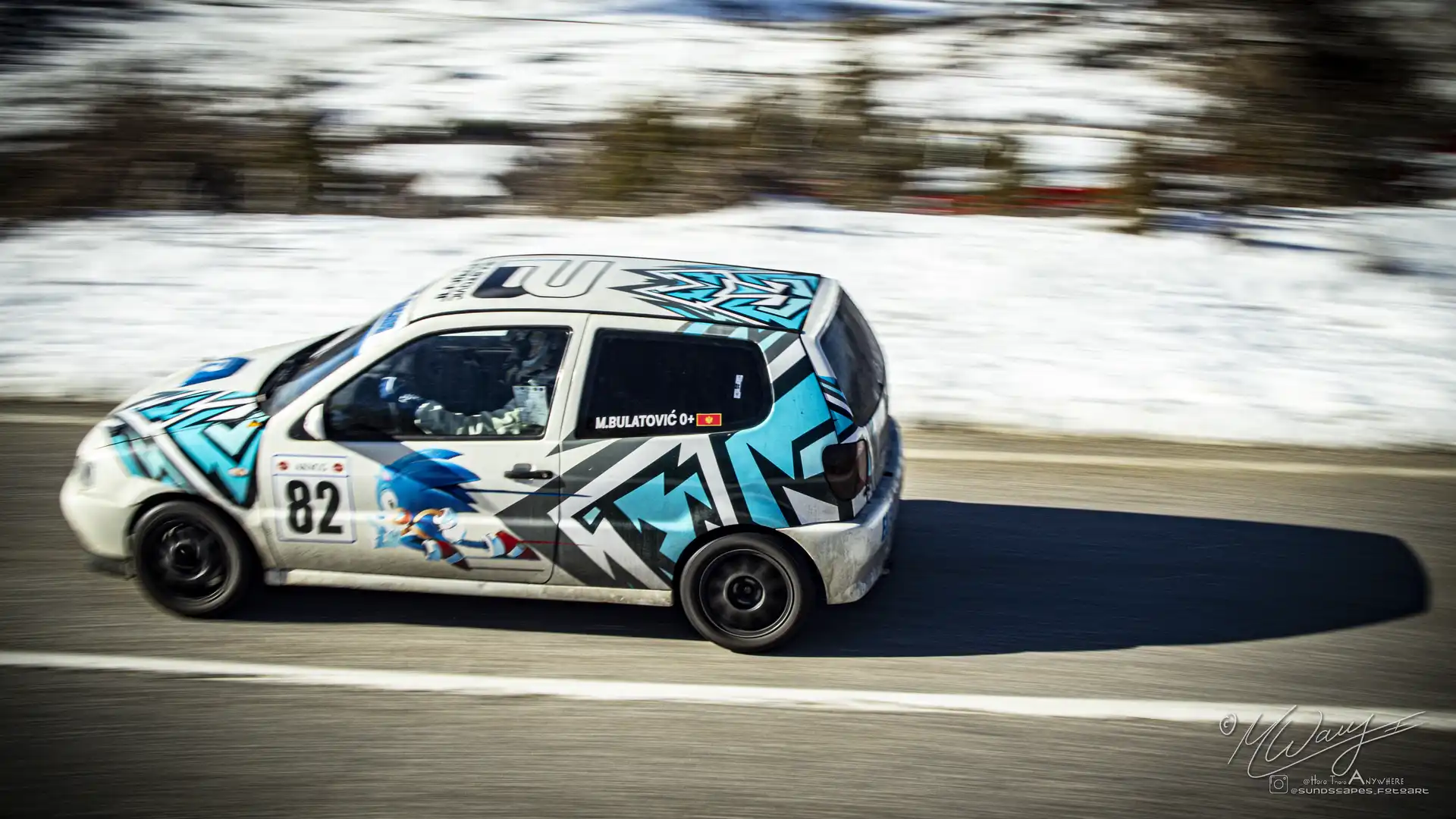 A race car on a snowy mountain road