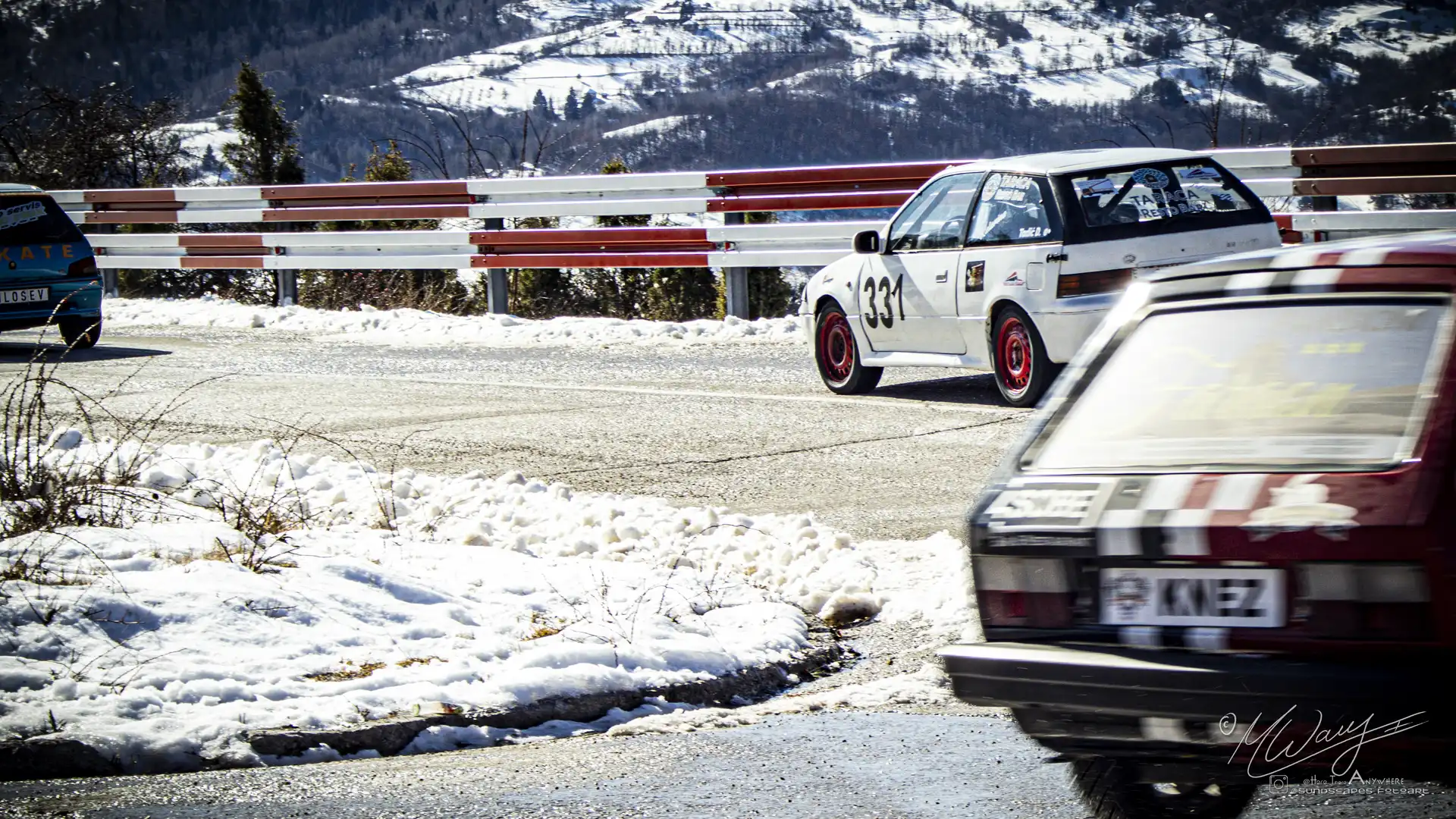 three cars on a road with snow