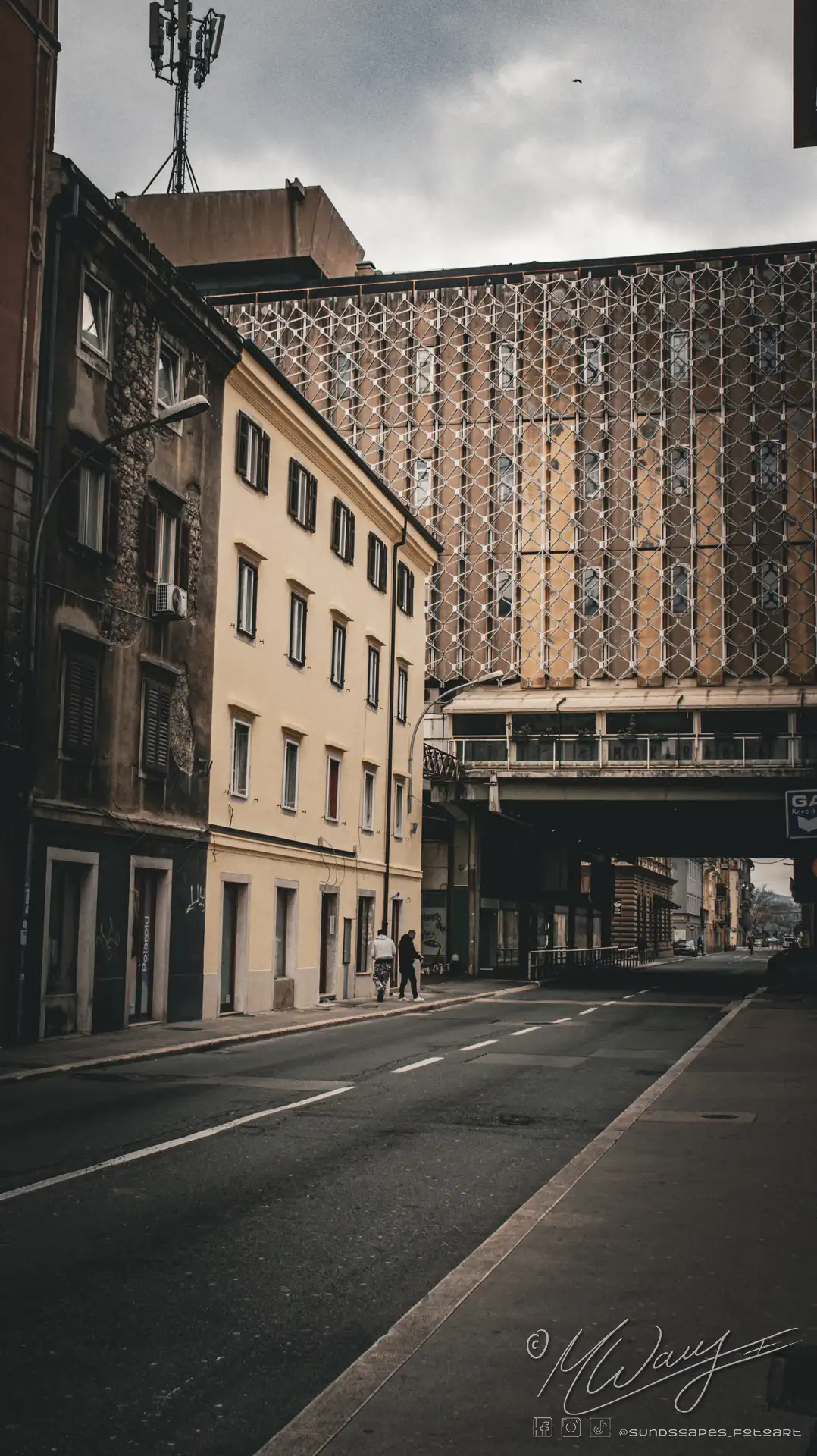 a street with buildings and a bridge