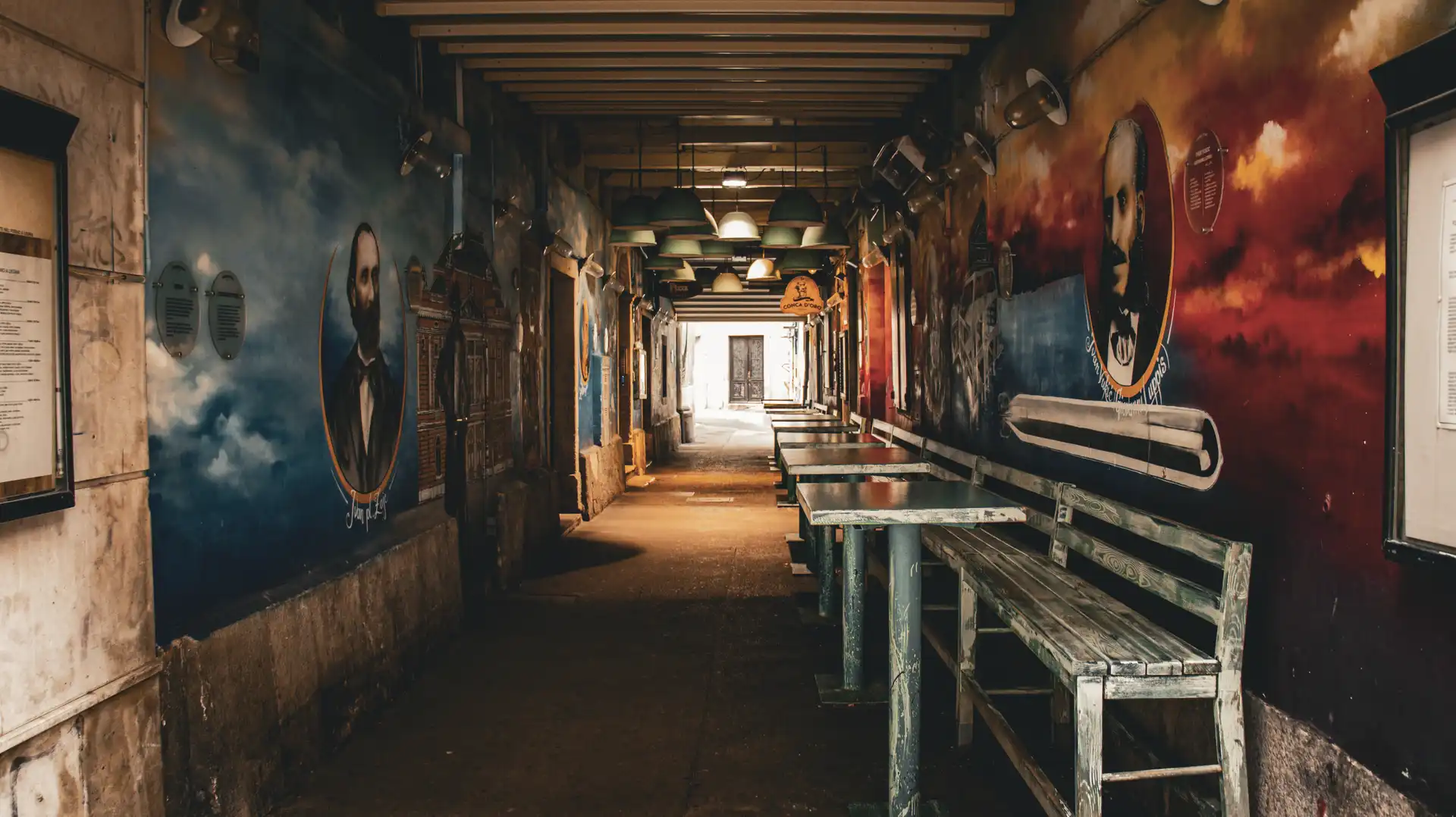 a long hallway with benches and tables