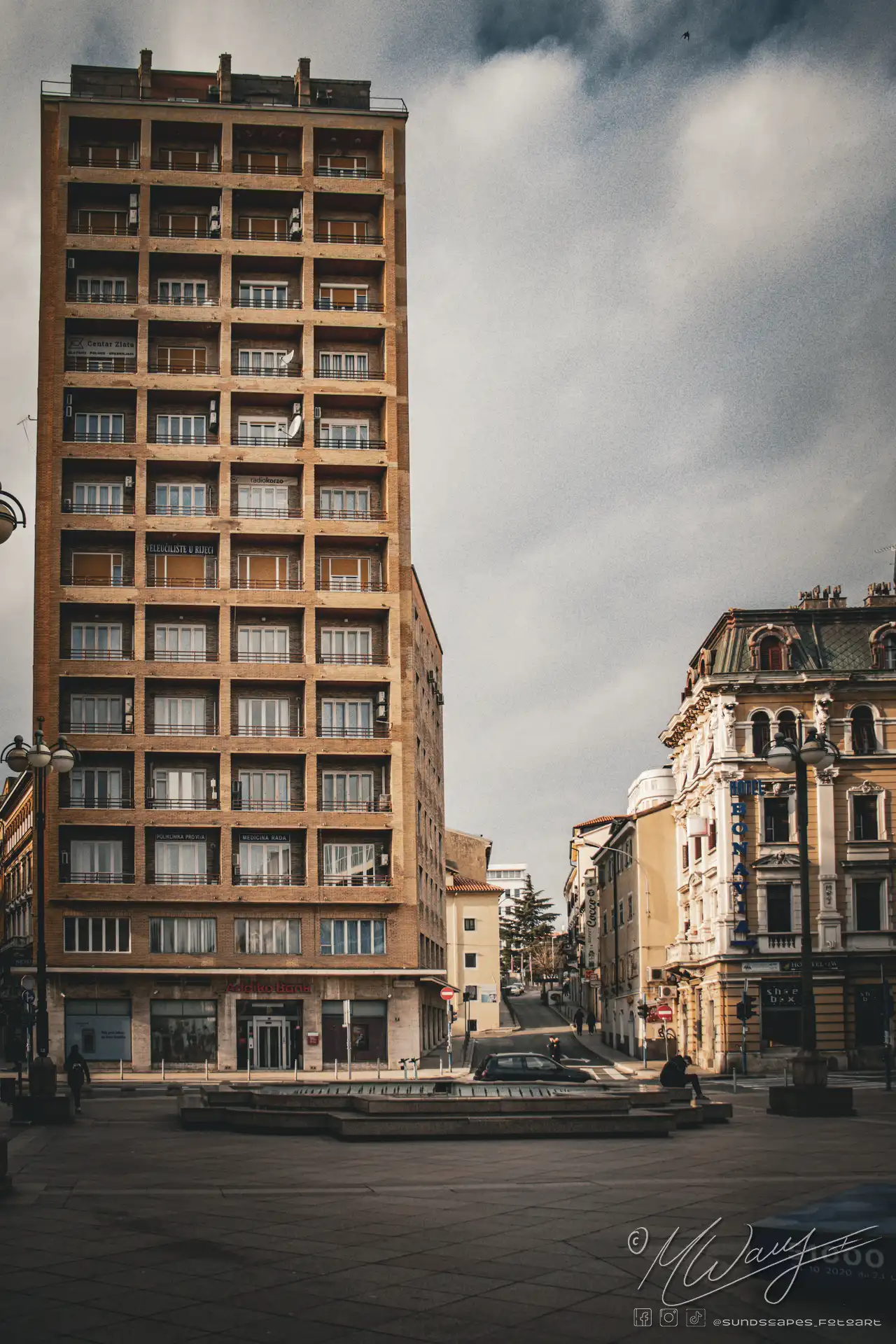 a street with buildings and a bridge