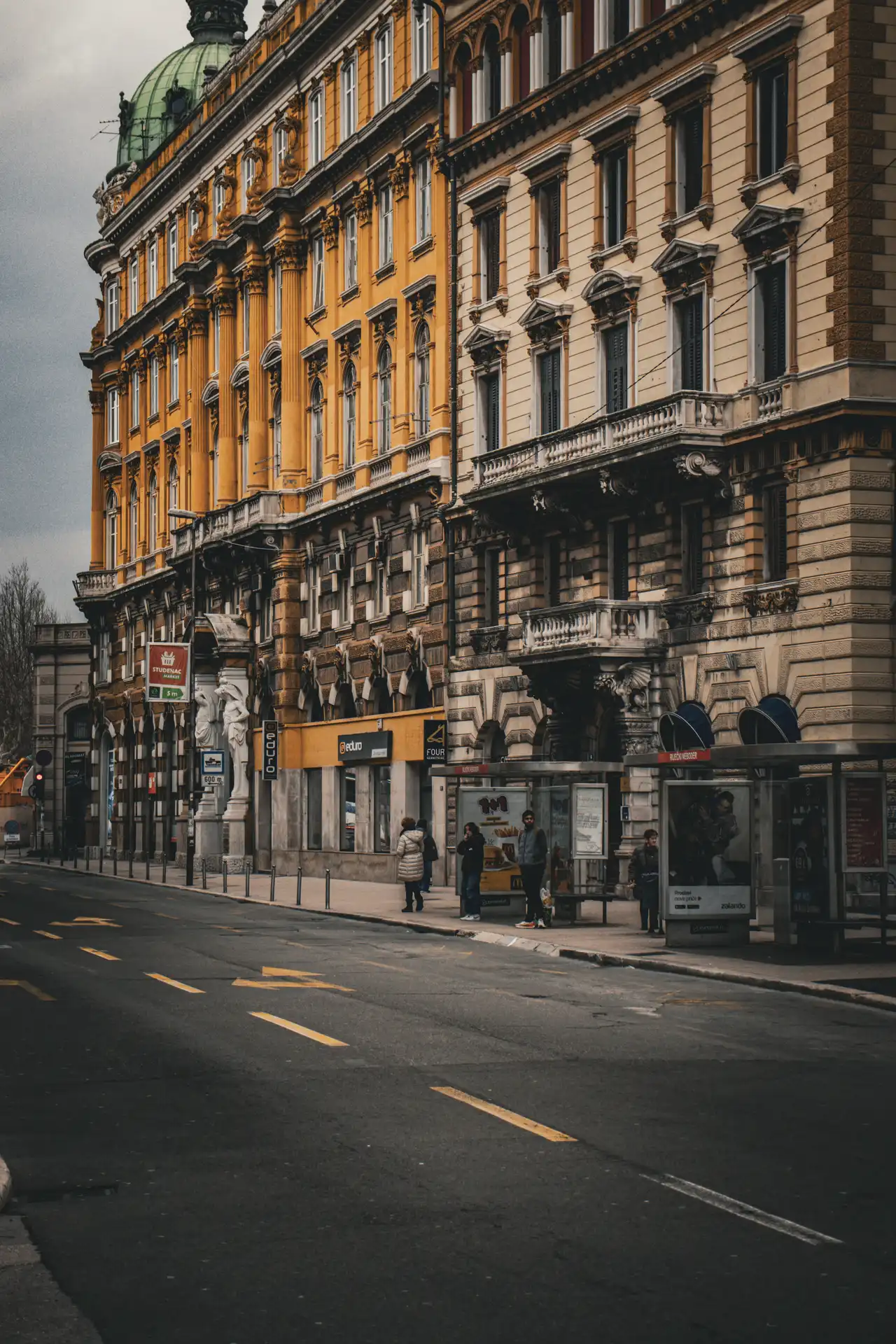 a street with a building and people on it