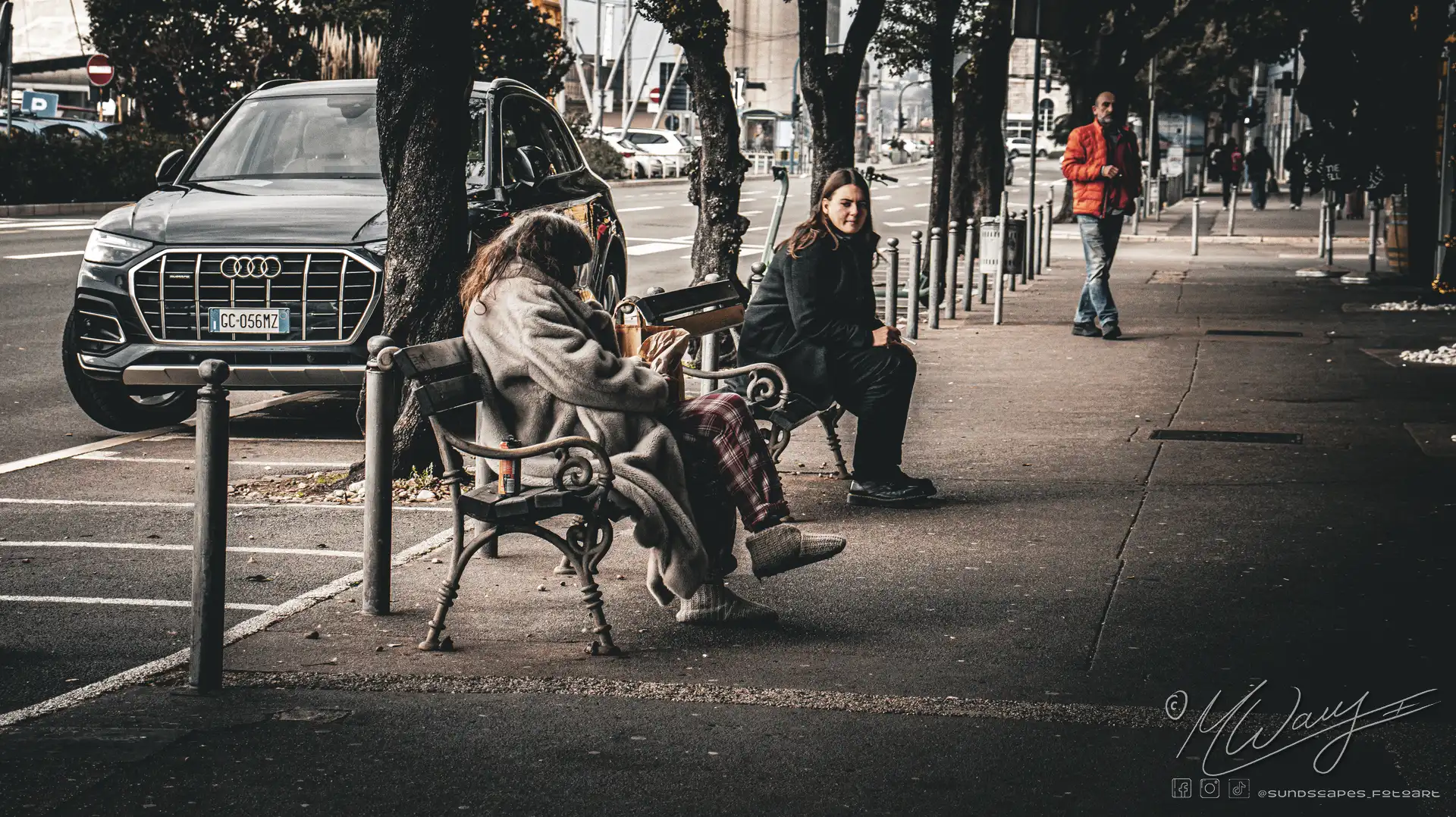 a woman sitting on a bench next to a woman