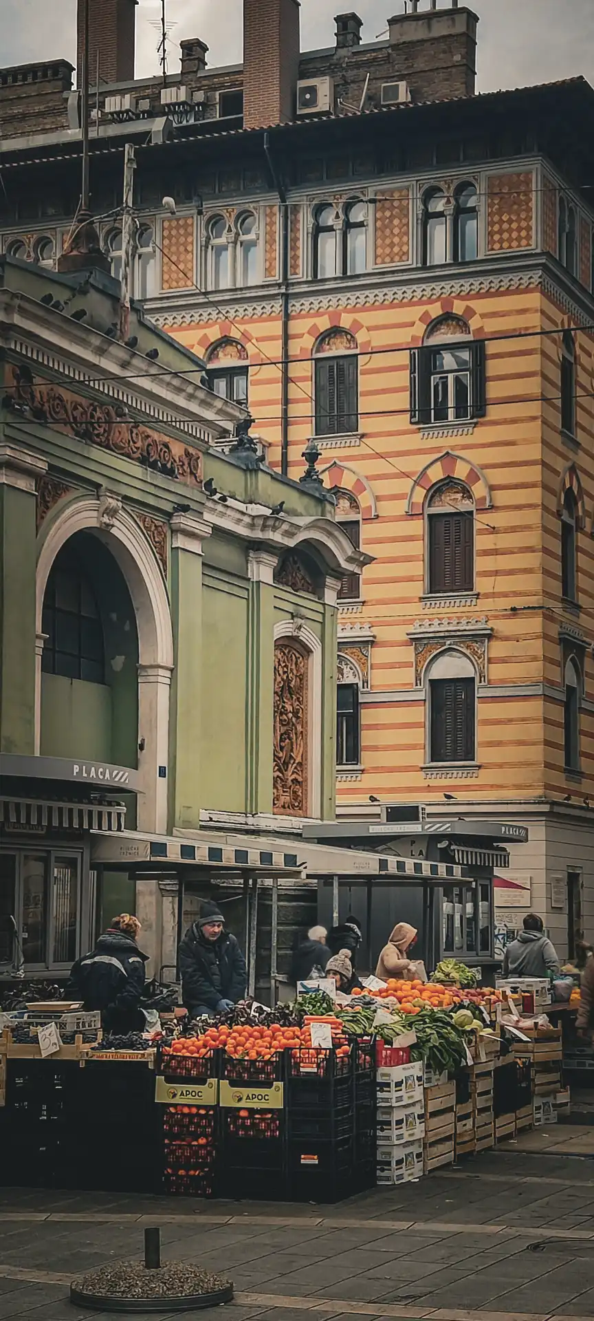 people walking on a sidewalk in front of a building